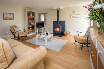 The wood-burner really sets the tone for this super-comfy living area.
