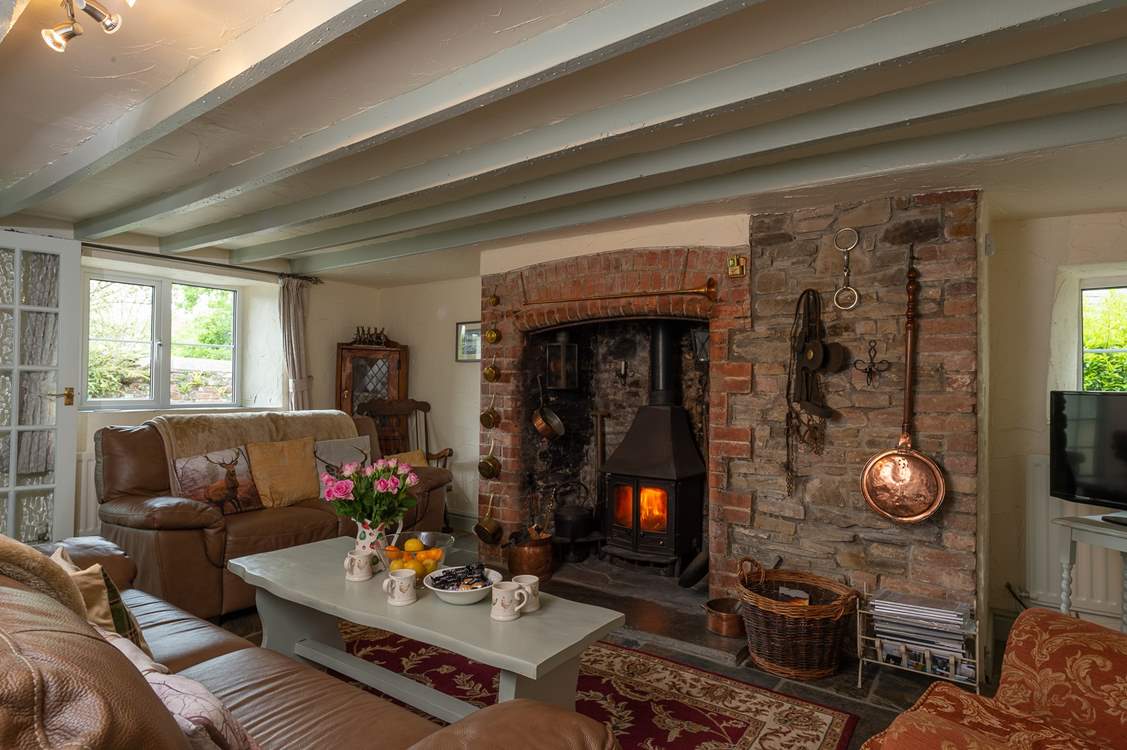The sitting-room with the inglenook fireplace is at the heart of the cottage.