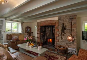 The sitting-room with the inglenook fireplace is at the heart of the cottage.
