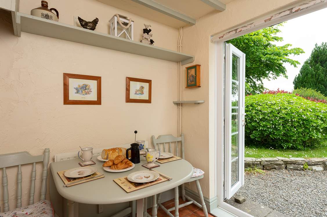 French windows lead from the kitchen/breakfast-room straight out into the large garden.