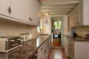 The galley-style kitchen has a utility-room - also home to the electric cooker - and shower-room at the far end.