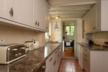 The galley-style kitchen has a utility-room - also home to the electric cooker - and shower-room at the far end.