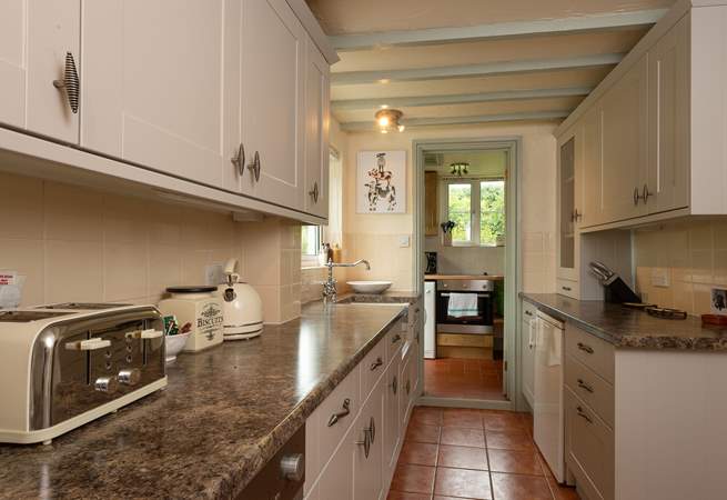 The galley-style kitchen has a utility-room - also home to the electric cooker - and shower-room at the far end.