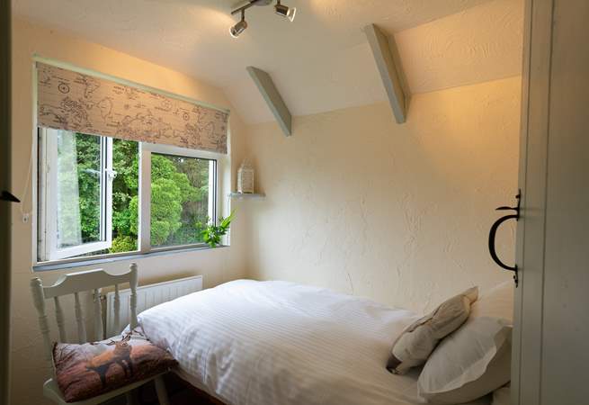 The single bedroom looks out over the large garden and across the fields beyond it.