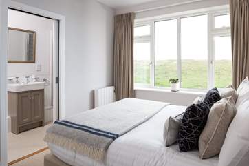 This bedroom has a stylish en suite shower-room.