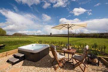 The wide open meadow in front of the hut is all yours, stretching out to the field boundary and the view beyond.