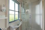 The en suite shower-room includes a wash-basin and WC.