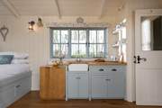 The kitchen is compact but well-equipped, featuring a two-ring hob, fridge, kettle and toaster.