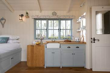 The kitchen is compact but well-equipped, featuring a two-ring hob, fridge, kettle and toaster.