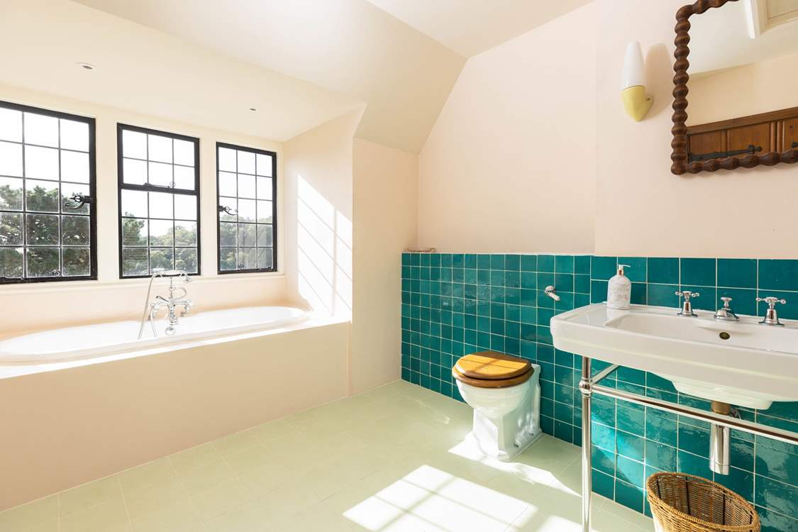 The en suite bathroom to Bedroom 1 with bath and separate shower.