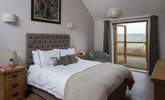 Bedroom 2 has a super comfy 5ft king-size bed and French doors that open onto the south-facing terrace. - Thumbnail Image