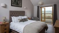 Bedroom 2 has a super comfy 5ft king-size bed and French doors that open onto the south-facing terrace.