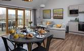 The open plan kitchen/dining/living space shares the beautiful view. - Thumbnail Image