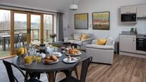 The open plan kitchen/dining/living space shares the beautiful view.