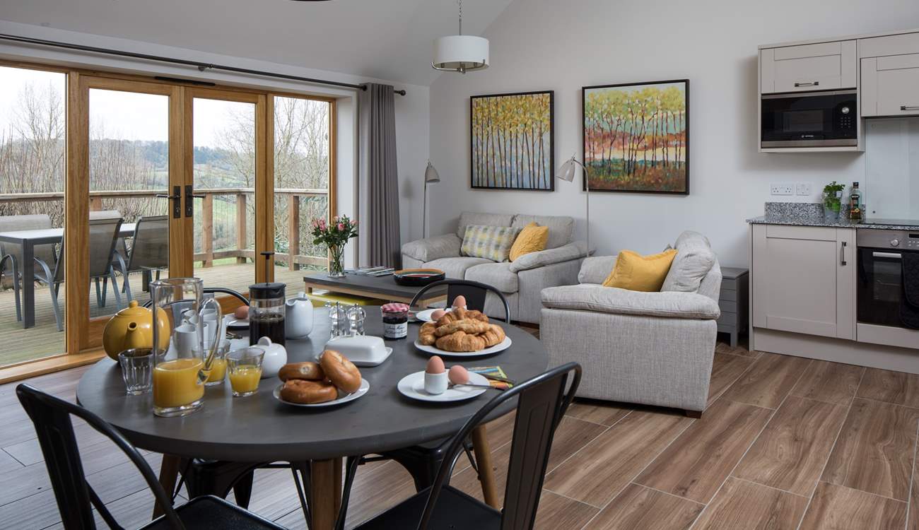 The open plan kitchen/dining/living space shares the beautiful view.