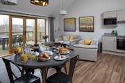The open plan kitchen/dining/living space shares the beautiful view.