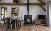 The open plan living/dining/sitting room has a cosy wood-burner for cooler evenings. - Thumbnail Image