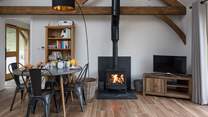The open plan living/dining/sitting-room has a cosy wood-burner for cooler evenings.