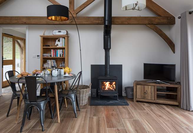 The open plan living/dining/sitting room has a cosy wood-burner for cooler evenings.