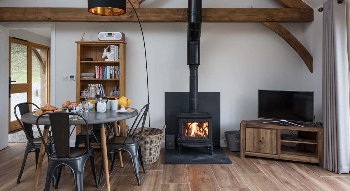 The open plan living/dining/sitting room has a cosy wood-burner for cooler evenings.