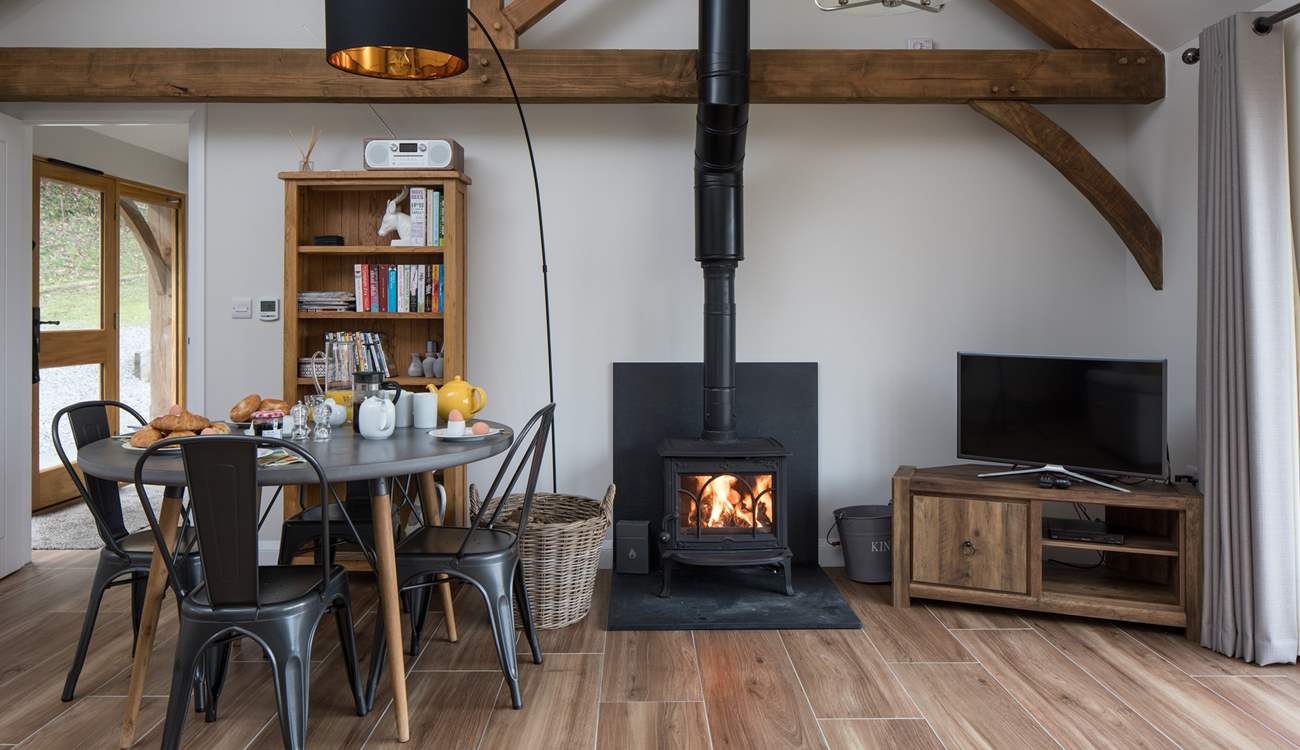 The open plan living/dining/sitting room has a cosy wood-burner for cooler evenings.