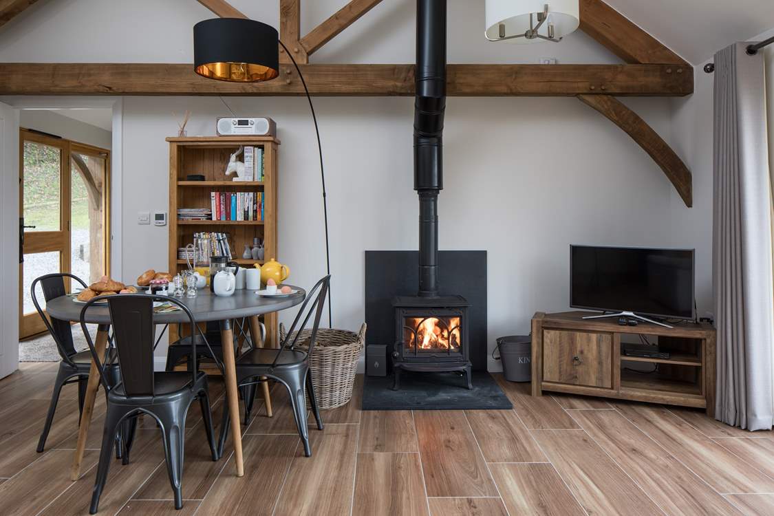 The open plan living/dining/sitting room has a cosy wood-burner for cooler evenings.