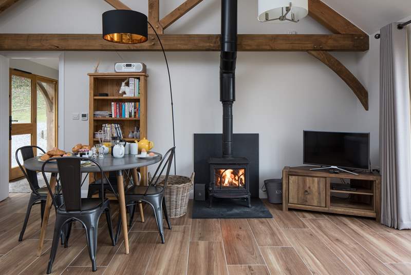The open plan living/dining/sitting room has a cosy wood-burner for cooler evenings.