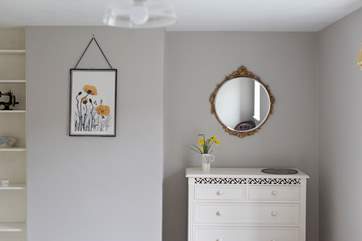 Bedroom 2 decorated in restful shades of mustard and grey.