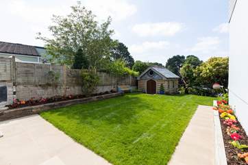 The lawned garden wraps around the side and front of the house.