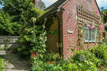 Flowers adorn Poppets Cottage.