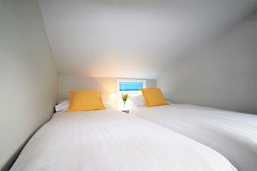 This twin bedroom, situated to the rear of the property has restricted head height