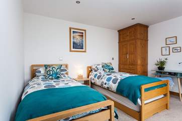 The twin bedroom is bright and colourful.