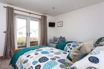 The twin bedroom has patio doors leading out to the front garden. (It may be worth keeping these doors locked if children are staying in here)