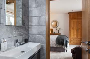 The en suite is beautifully styled in greys and whites.