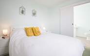 Bedroom 4 is the only room located on the first floor, with its own en suite bathroom and sea glimpses.