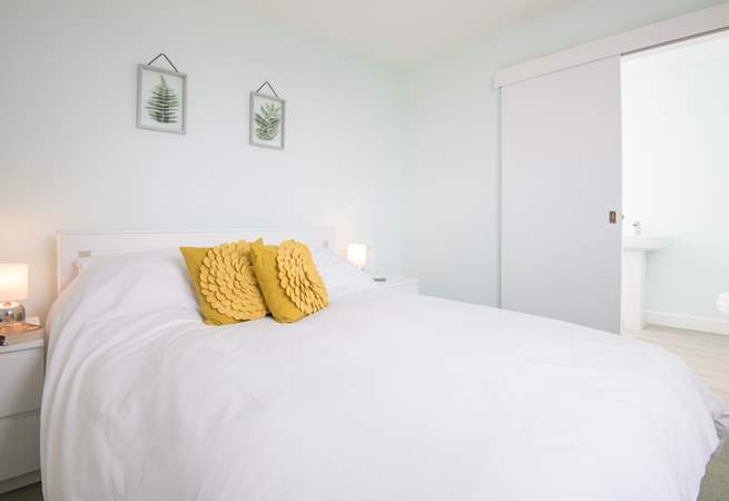 Bedroom four is the only room located on the first floor, with its own en suite bathroom and sea glimpses.