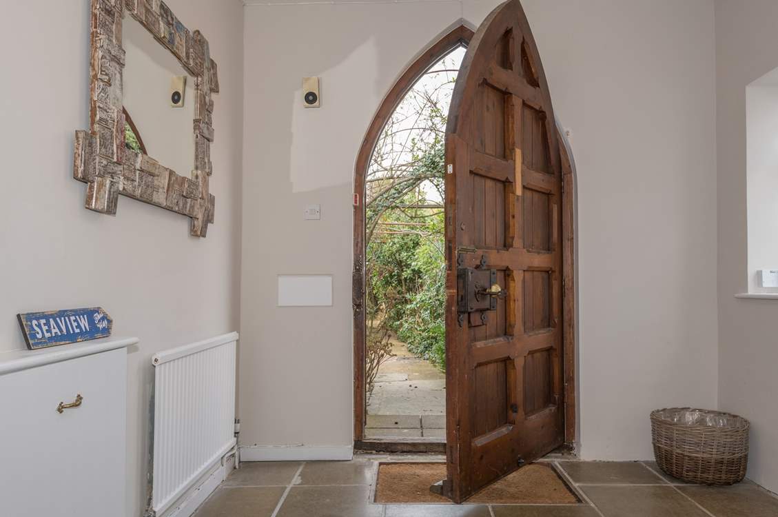 This amazing church style door opens up to the large entrance hall.