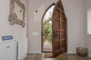 This amazing church style door opens up to the large entrance hall.