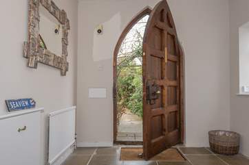 This amazing church style door opens up to the large entrance hall.