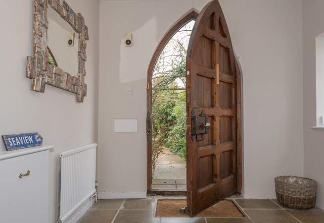 This amazing church style door opens up to the large entrance hall.