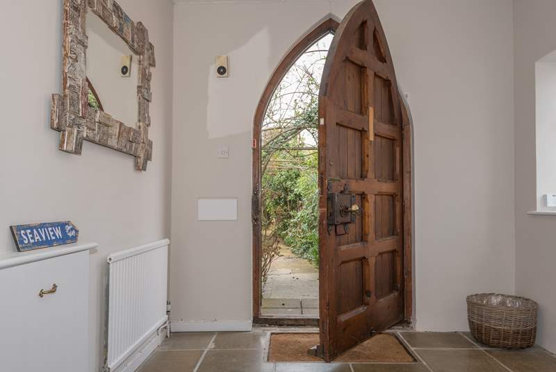 This amazing church style door opens up to the large entrance hall.