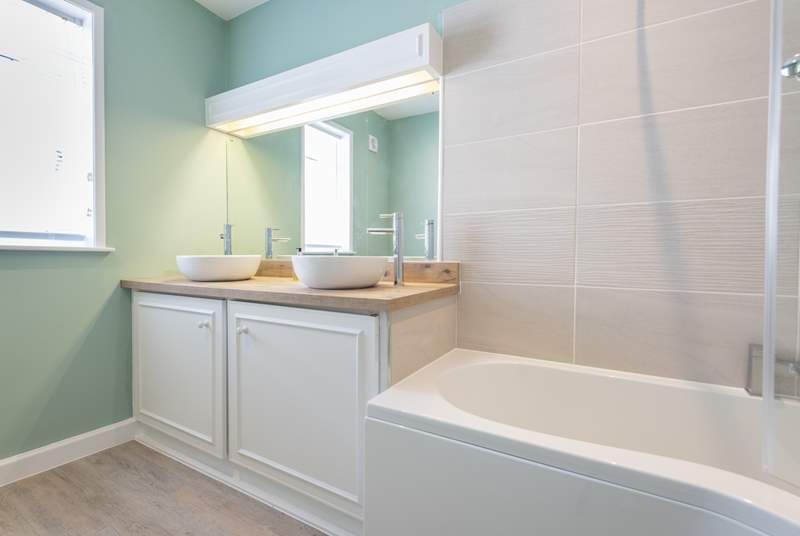 The en suite bathroom to the master bedroom has a 'his and hers' double wash-basin.