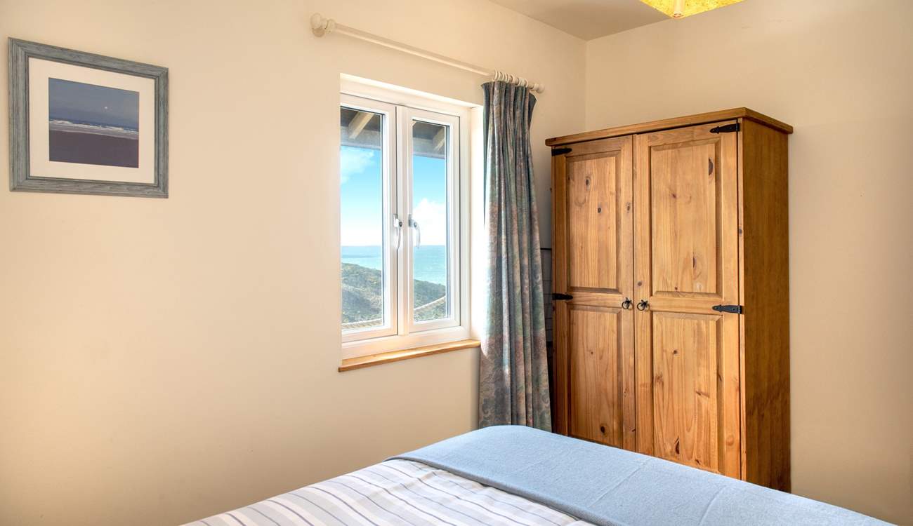 The bedroom is tucked away at the back of the cabin.