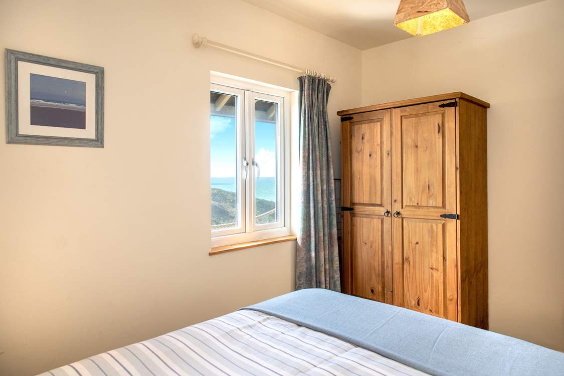 The bedroom is tucked away at the back of the cabin.