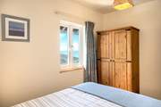 The bedroom is tucked away at the back of the cabin.