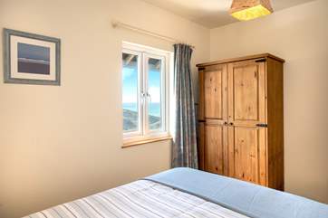 The bedroom is tucked away at the back of the cabin.