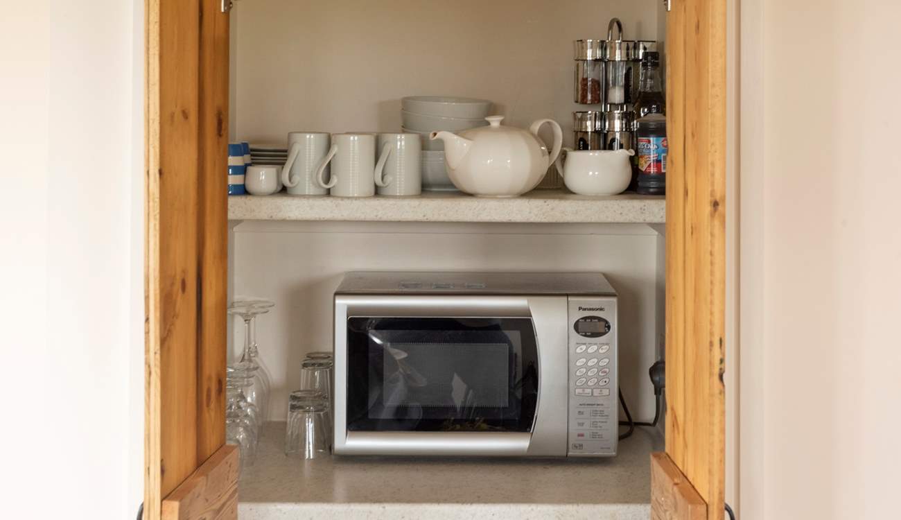The kitchen has a hidden cupboard full of equipment.