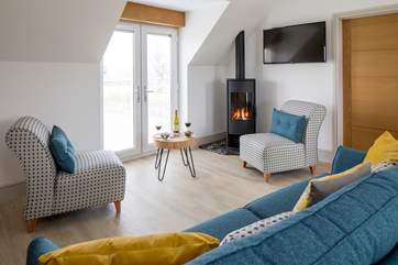 The open plan sitting/dining/kitchen-area has a wood-burner effect gas fire for chilly evenings.