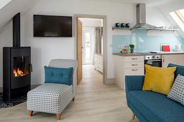The open plan sitting/dining/kitchen-area has a wood-burner effect gas fire for chilly evenings.