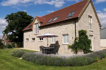 Beautifully presented Meadows Barn. The large patio is ideal for a barbecue and lazy al fresco dining in the summer. The owner's home is offset behind to the left of this image (out of shot).